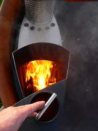 A TubSub heater burning fire wood in a Lignum Hot Tub